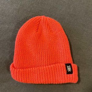 Salmon colored knit beanie with space robot tag